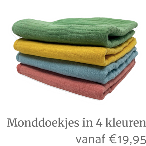 Stapeltjes katoenen monddoekjes of spuugdoekjes in groen, geel blauw en roze
